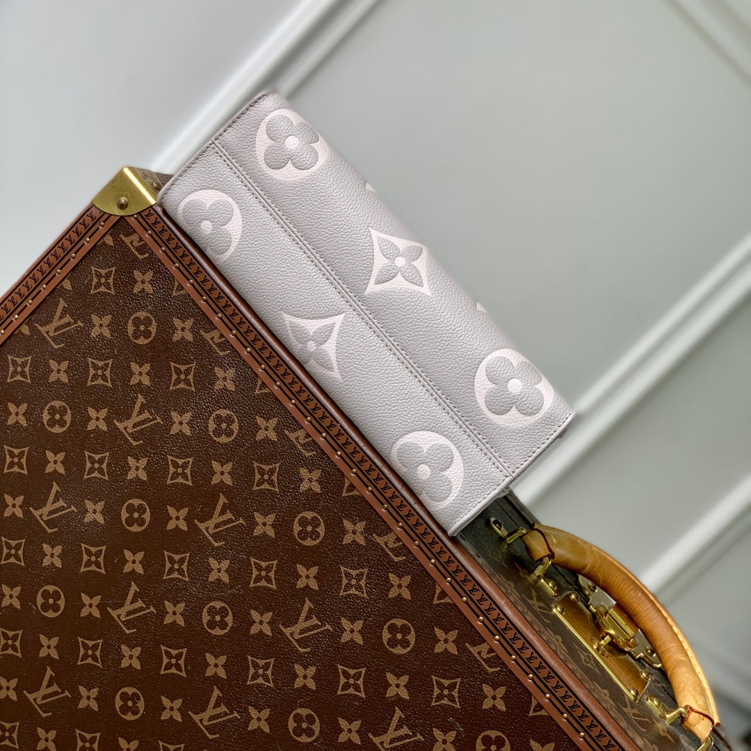 ONTHEGO EAST WEST BAG 25 IN BICOLOR MONOGRAM EMPREINTE LEATHER